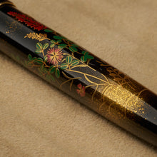Load image into Gallery viewer, Close up to the green, gold dust and red lacquer foliage with flowers  painted on the pen&#39;s barrel. 
