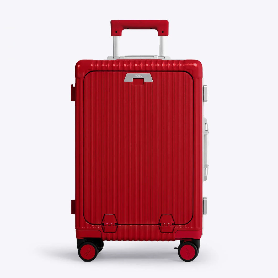 Front panel view of the red suitcase. The telescopic handle is partly extended. 