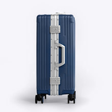 Load image into Gallery viewer, Side panel view of the navy blue suitcase showing a grab handle, and two TSA approved three-digit combination locks. 
