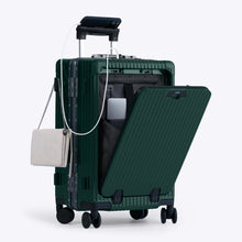 Load image into Gallery viewer, Angled front view of the green carry-on with the front panel opened. It is arranged with a charging cellphone, a small purse, and a laptop in its compartment. 
