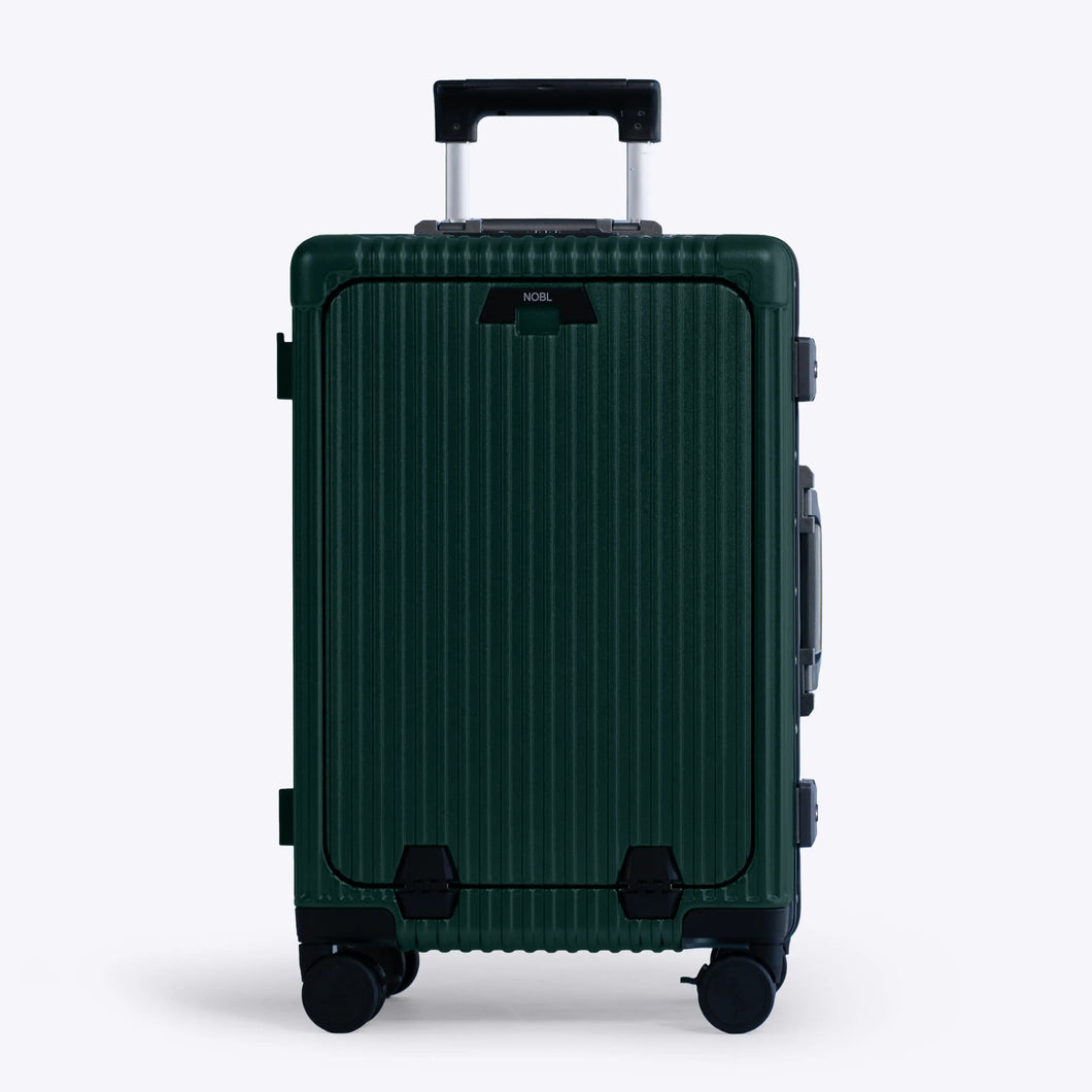 Front panel view of the green suitcase. The telescopic handle is partly extended.