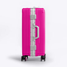 Load image into Gallery viewer, Side panel view of the hot pink suitcase showing a grab handle, and two TSA approved three-digit combination locks. 

