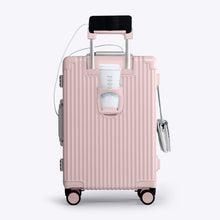 Load image into Gallery viewer, Back panel view of the pink suitcase showing a phone held by the telescopic handle and a hot drink in the cup holder.
