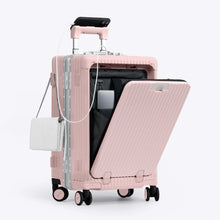 Load image into Gallery viewer, Angled front view of the pink colored carry-on with the front panel opened. It is arranged with a charging cellphone, a small purse, and a laptop in its compartment. 
