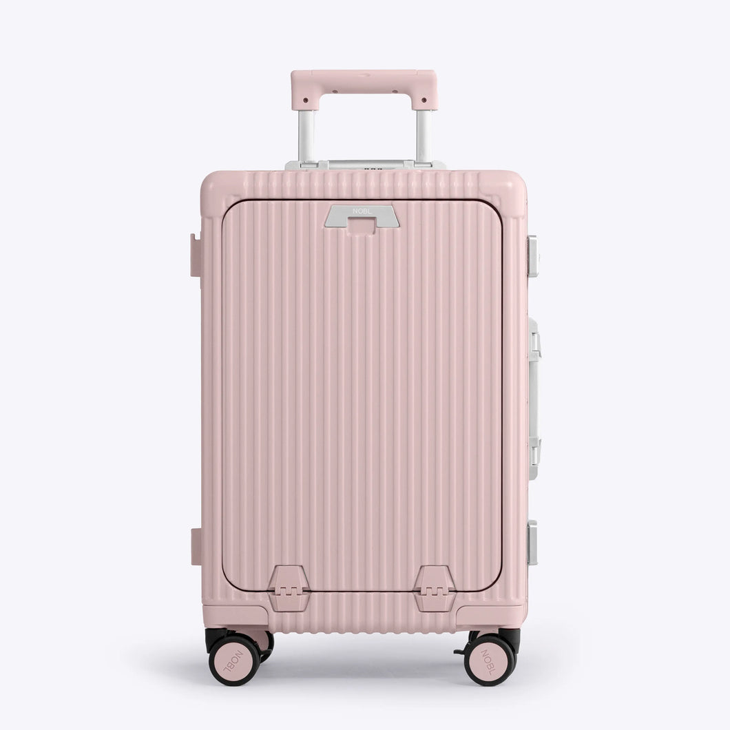Front panel view of the pink suitcase. The telescopic handle is partly extended. 