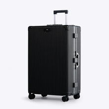 Load image into Gallery viewer, Angled front view of the large black suitcase with silver colored accents. The telescopic handle is partly extended. 
