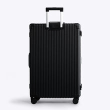 Load image into Gallery viewer, Back panel view of the black suitcase with the handle extended. 

