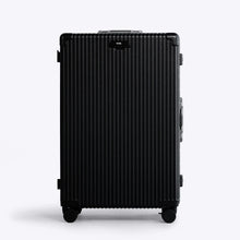Load image into Gallery viewer, Front panel view of the large black suitcase . The telescopic handle is retracted. 
