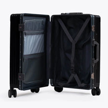 Load image into Gallery viewer, Interior view of the suitcase. The front panel side has a zipper-closing divider with organizational pockets. The back panel has a set of straps to hold your contents in place.
