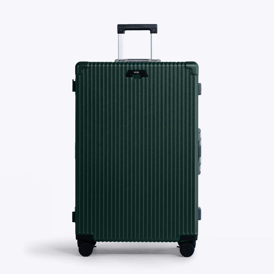 Front panel view of the large green suitcase. The telescopic handle is extended. 