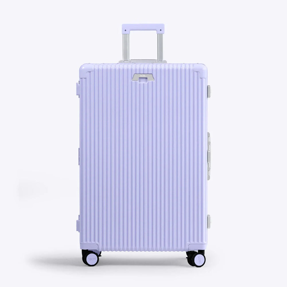 Front panel view of the lavender suitcase with the telescopic handle partly extended. 