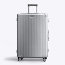 Load image into Gallery viewer, Front panel view of the silver suitcase with the telescopic handle extended. 
