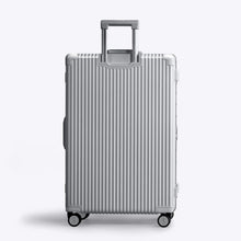Load image into Gallery viewer, Back panel view of the silver suitcase. The telescopic handle is extended. 
