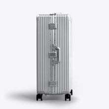Load image into Gallery viewer, Side panel view of the silver-colored suitcase. This side features a grab handle and two TSA approved three-digit combination locks. 
