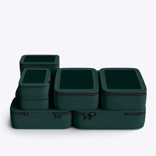 Load image into Gallery viewer, Set of dark green packing cubes with zippers on a light gray background
