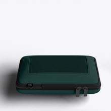 Load image into Gallery viewer, A green packing case with black accents on a white background. 
