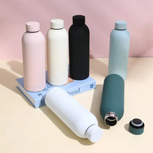 Load image into Gallery viewer, Set of colorful water bottles on a pink and beige background
