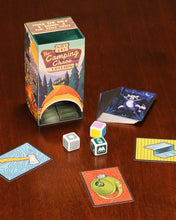 Load image into Gallery viewer, The packaging box with the dice and cards arranged on a wooden table. 
