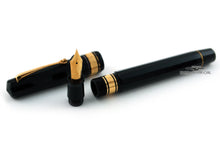 Load image into Gallery viewer, Black fountain pen with gold accents on a white background.

