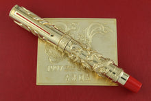 Load image into Gallery viewer, Decorative pen with gold and red accents on a red background
