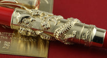 Load image into Gallery viewer, Decorative pen with intricate designs on a red background
