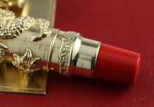 Load image into Gallery viewer, Close-up of the pen on a red background.
