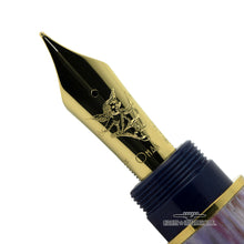 Load image into Gallery viewer, Close up to the cherub and OMAS logo engraved on the gold nib. 
