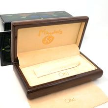 Load image into Gallery viewer, Interior view of the wooden presentation box arranged with the outer box, pen sleeve, and polishing cloth on a white background. 
