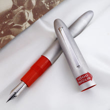 Load image into Gallery viewer, The fountain pen arranged with the cap on top of it. 
