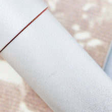 Load image into Gallery viewer, Close up to a small scuff on the pen.
