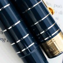 Load image into Gallery viewer, Close up to the silver rings on the cap and pen body.
