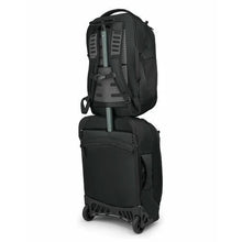 Load image into Gallery viewer, Back panel view of the black backpack attached to a suitcase's handle. 
