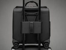 Load image into Gallery viewer, Briggs &amp; Riley Rhapsody Wheeled Cabin Bag - Shown in Black

Image of Attachment Feature allowing this Wheeled Cabin Bag to ride along the telescoping handles of your carry-on Wheeled Trolley Bag.

Dimensions:  16 x 14 x 8.5 in / 40.6 x 35.6 x 21.6 cm (includes wheels an handles)
