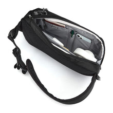 Load image into Gallery viewer, Side panel view of the black sling bag filled with accessories. 
