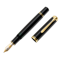 Load image into Gallery viewer, The black fountain pen uncapped, with gold accents, displaying the pelikan two tone nib on a white background
