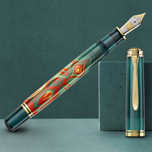 Load image into Gallery viewer, Fountain pen with green and gold design on a green background.
