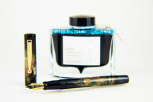 Load image into Gallery viewer, The Ebisu Fountain Pen arranged with the blue ink bottle behind it. 
