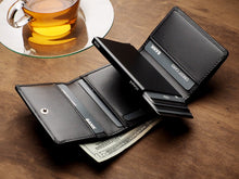 Load image into Gallery viewer, Angled view of the opened Pularys Boston wallet in black on a brown wooden table. There are cards and a $20 bill peeking from the compartments. 
