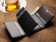 Load image into Gallery viewer, Angled view of the Pularys Boston Brown leather wallet with the card case showing the cards propped out. There is a $20 bill peeking from the cash compartment, and a tea cup set behind the wallet. 
