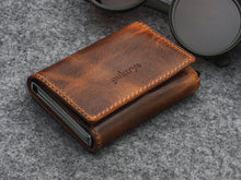 Load image into Gallery viewer, Angled view of the brown wallet. 
