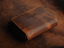 Load image into Gallery viewer, Angled close up to the brown wallet. 
