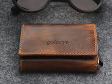 Load image into Gallery viewer, Angled front view of the brown wallet with pularys logo embossing. 

