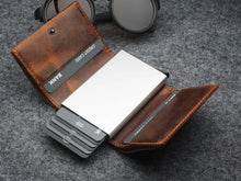Load image into Gallery viewer, Interior view of the wallet with eight credit cards in the compartments. 
