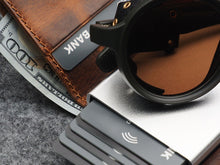 Load image into Gallery viewer, Close up to the credit card and bills compartment with a pair of sunglasses placed on top. 
