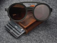 Load image into Gallery viewer, Angled view of the wallet arranged with six cards and sunglasses. 
