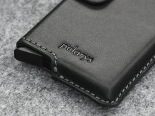 Load image into Gallery viewer, Close up to the wallet's Pularys logo embossing. 

