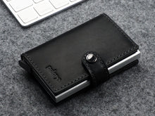 Load image into Gallery viewer, Angled front view of the wallet with snap closure and pulary's logo embossing. 
