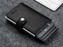 Load image into Gallery viewer, Angled front view of the black wallet with six credit cards peeking on the side. 
