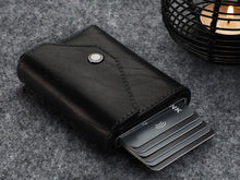 Load image into Gallery viewer, Angled view of the black wallet with six credit cards peeking from the side. 
