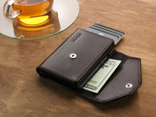 Load image into Gallery viewer, Interior view of the wallet with a bill and credit cards tucked in the compartments. 
